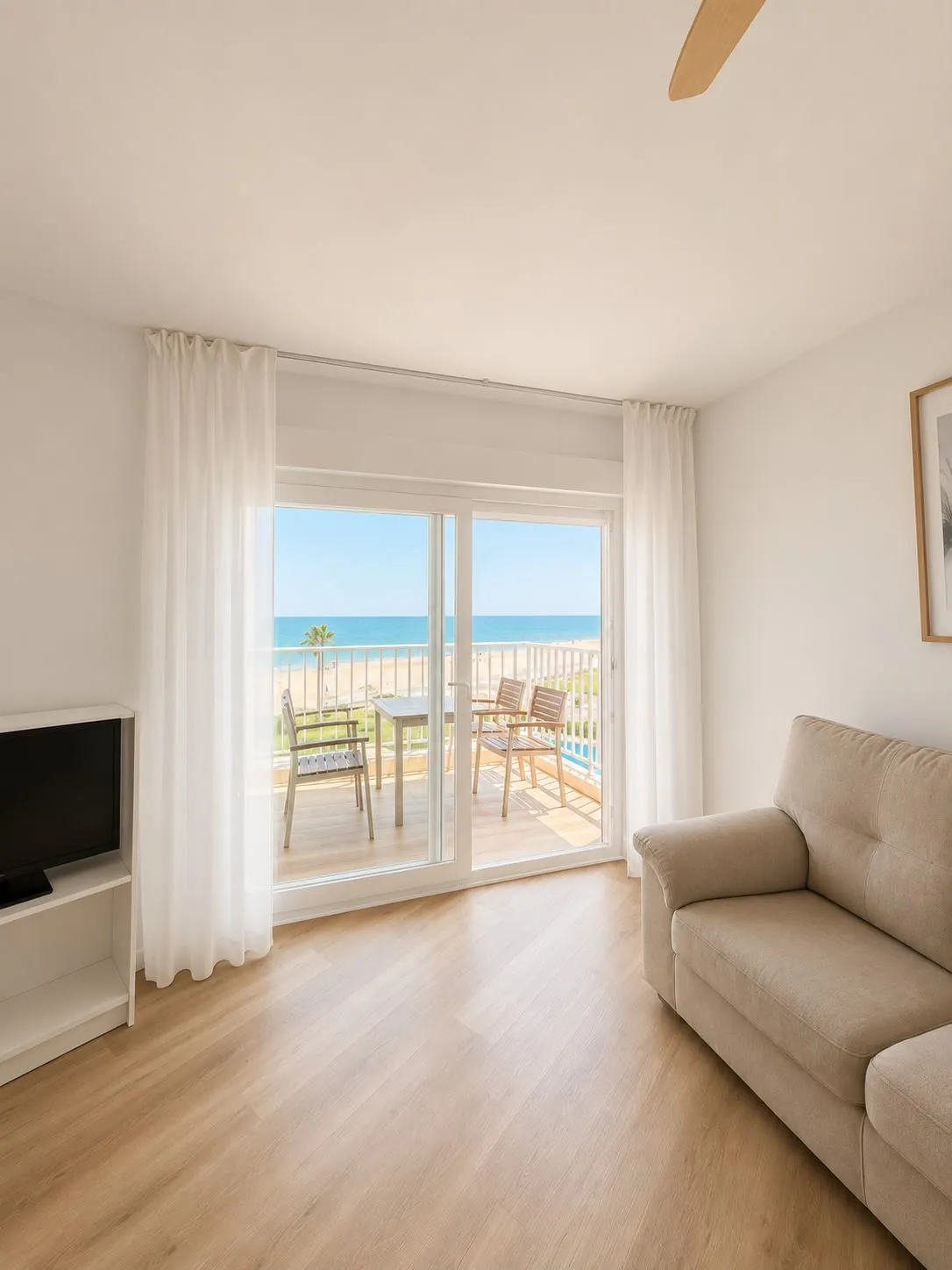 Living room with a sliding glass door to a terrace overlooking the sea